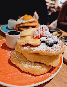 Fluffy Fruity Pancakes with fresh berries at Lloyd Coffee Eatery