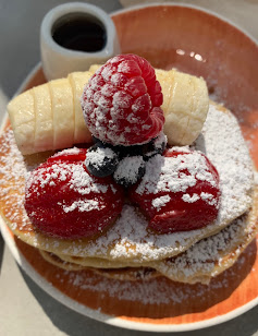 Pancakes with Berries and Syrup at Lloyd Coffee Eatery